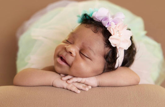 This adorable baby girl, is donning the Pastel Rainbow tutu and a delicate flower headband, which radiates pure joy as she peacefully snoozes. Perfect for any occasion.